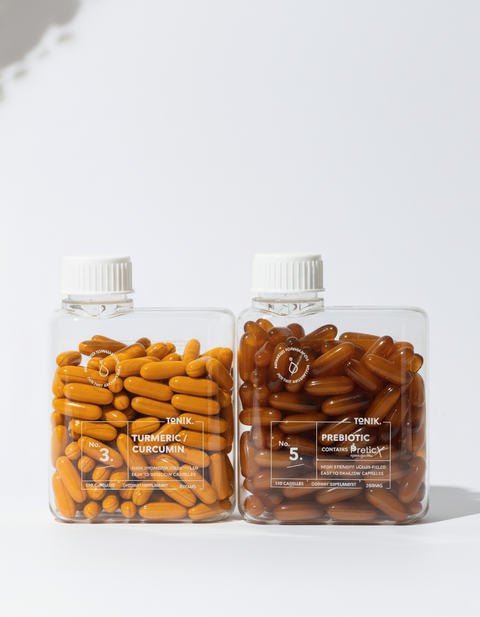 Two bottles of supplements with white caps on a light gray background