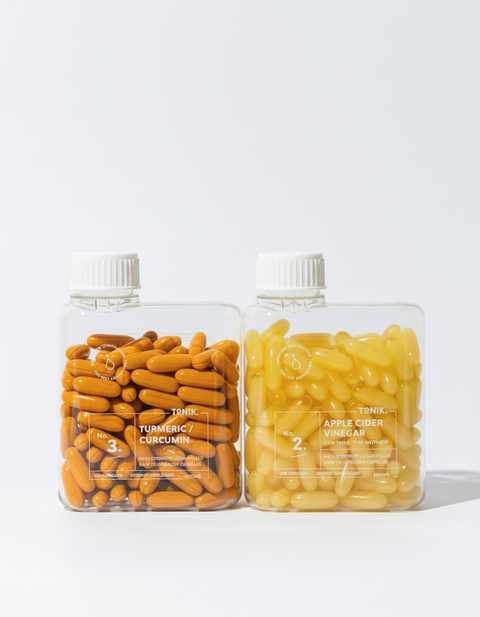 Two bottles labeled 'Turmeric + Curcumin' and 'Apple Cider Vinegar' on a white background